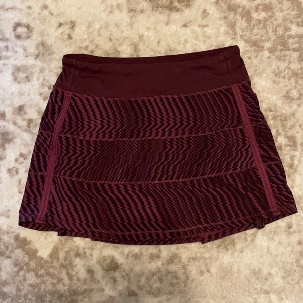 Burgundy and black Lululemon workout skirt.